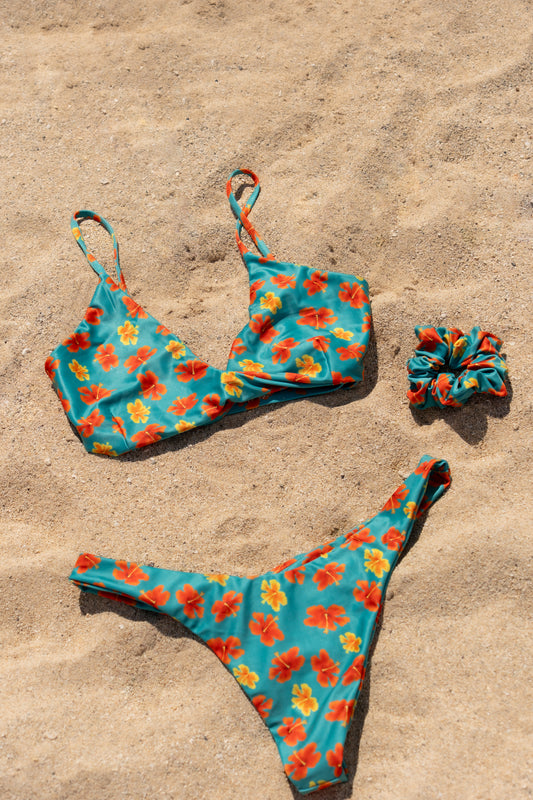 Floral bikini set with matching scrunchie on sand
