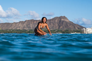 Girl surfing at Waikiki Hawaii